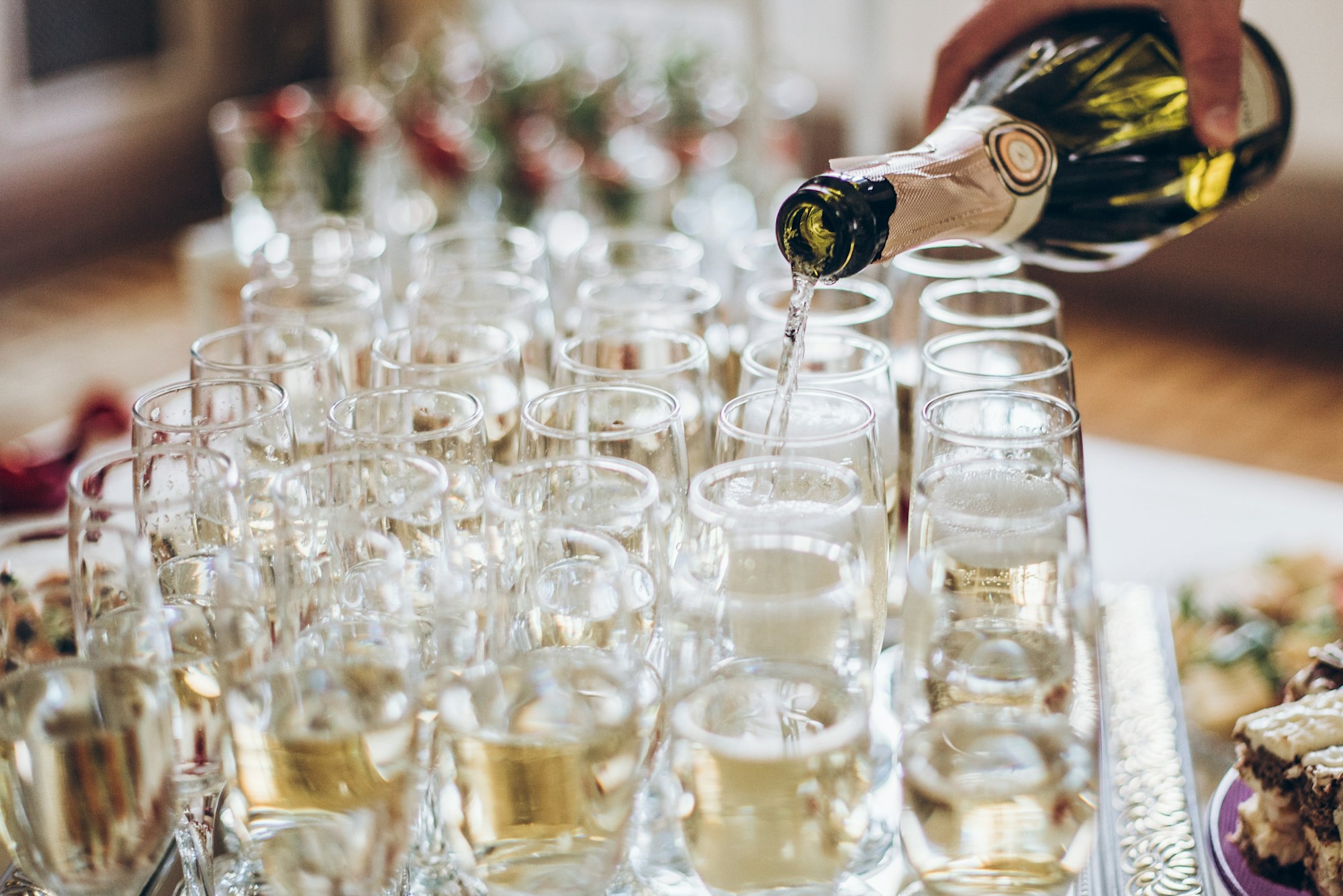 waiter-pouring-champagne-in-stylish-glasses-at-luxury-wedding-reception.jpg